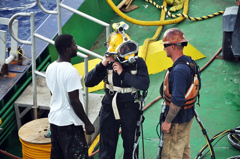 Dive team preparing a hard-hat diver