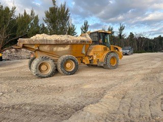 Articulated dump truck carrying fill