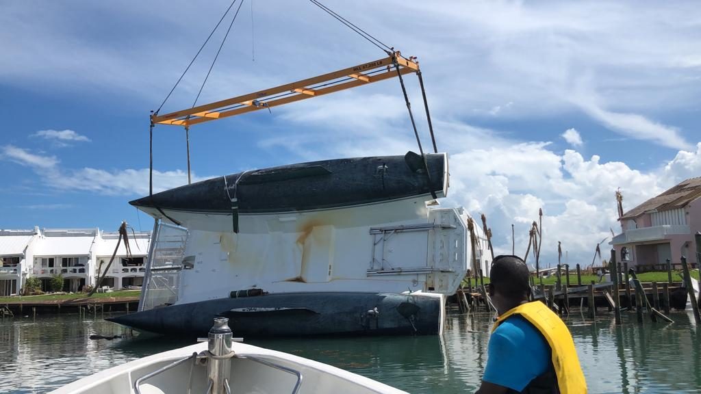 Capsized catamaran being lifted