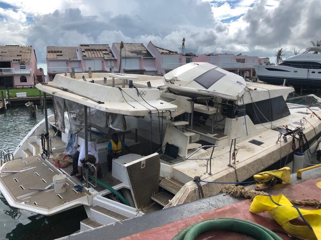 Storm-damaged catamaran being pumped out
